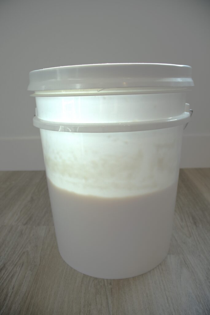 A five gallon bucket half way filled.
