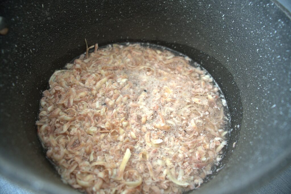 A shredded soap bar mixed with some water in a pot.